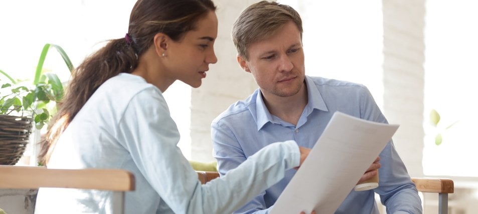 two students discussing a paper