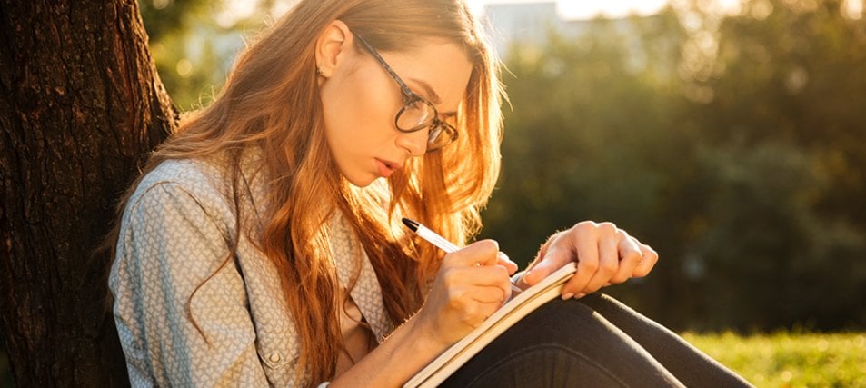 female student studying outside