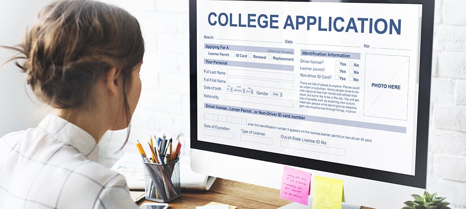 Student looking at college application on her computer screen.