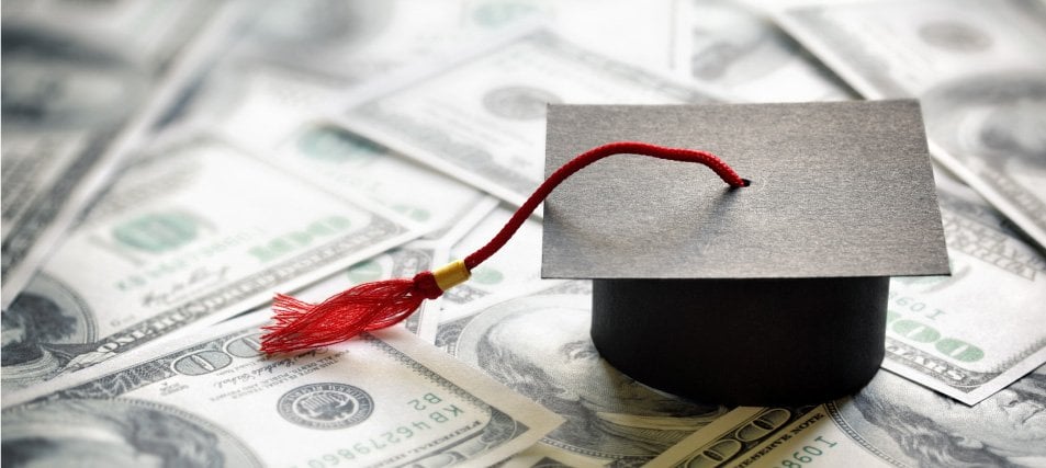 graduation cap over money