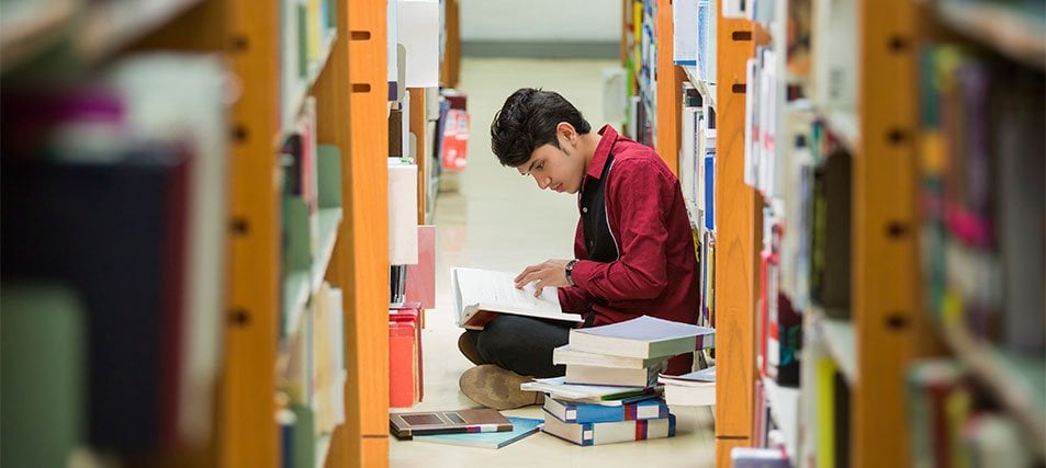 male student in the library