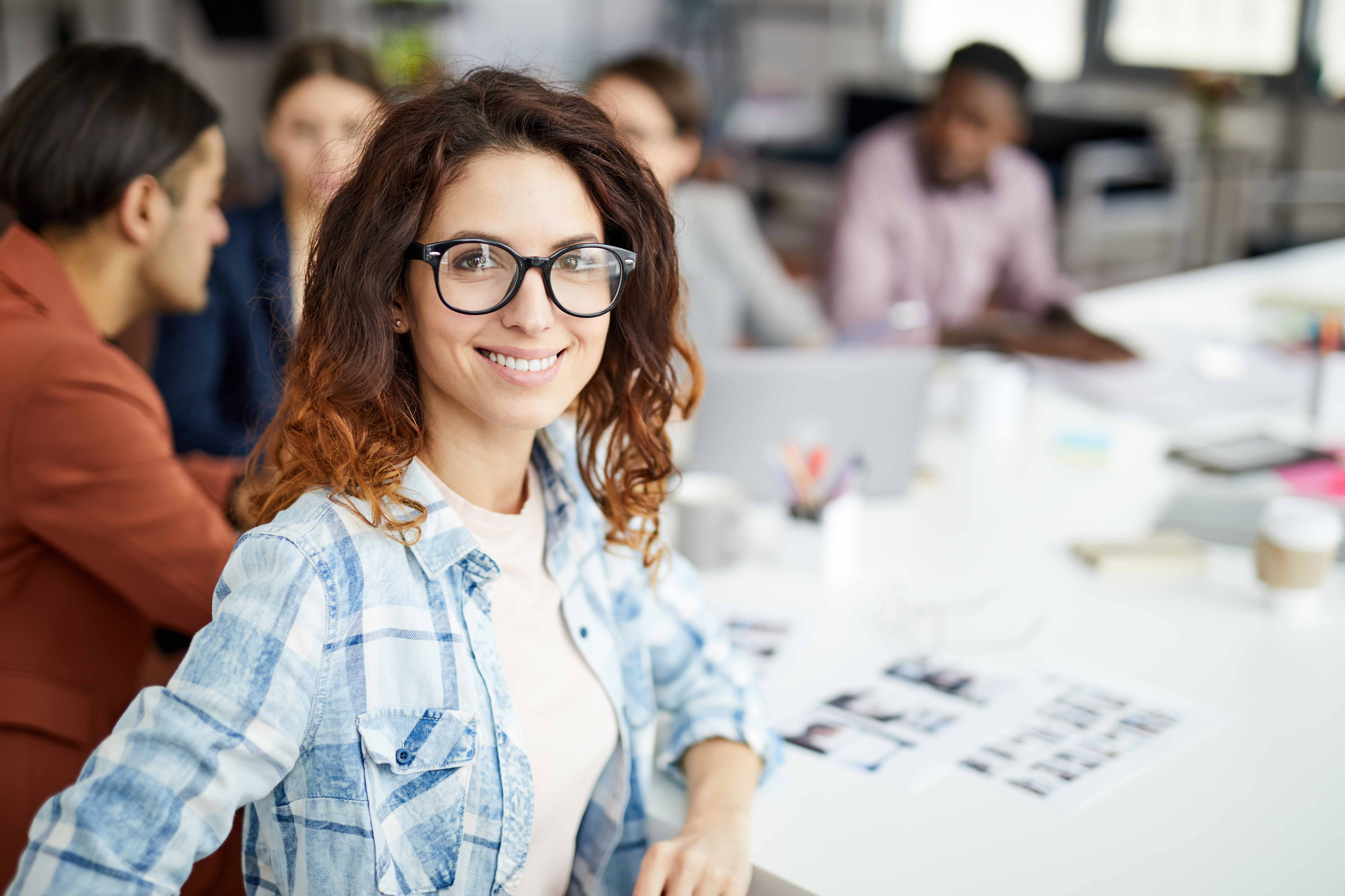 Female college student sitting at conference table in office