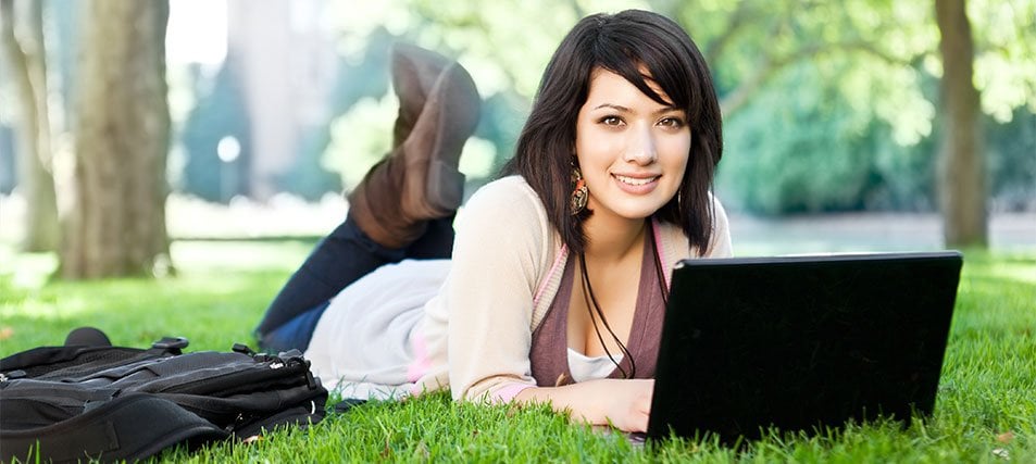 female student on the computer outside