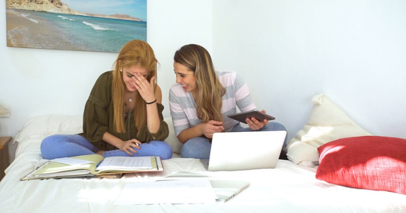 College roommates studying together in their dorm