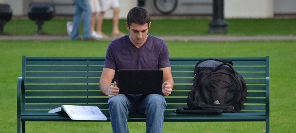 male student on a bench